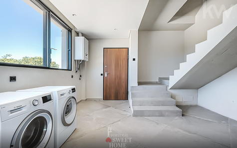 Laundry room with access to the garage and the upper floor