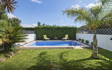 View of the garden and the 6m x 3m pool surrounded by a wooden deck